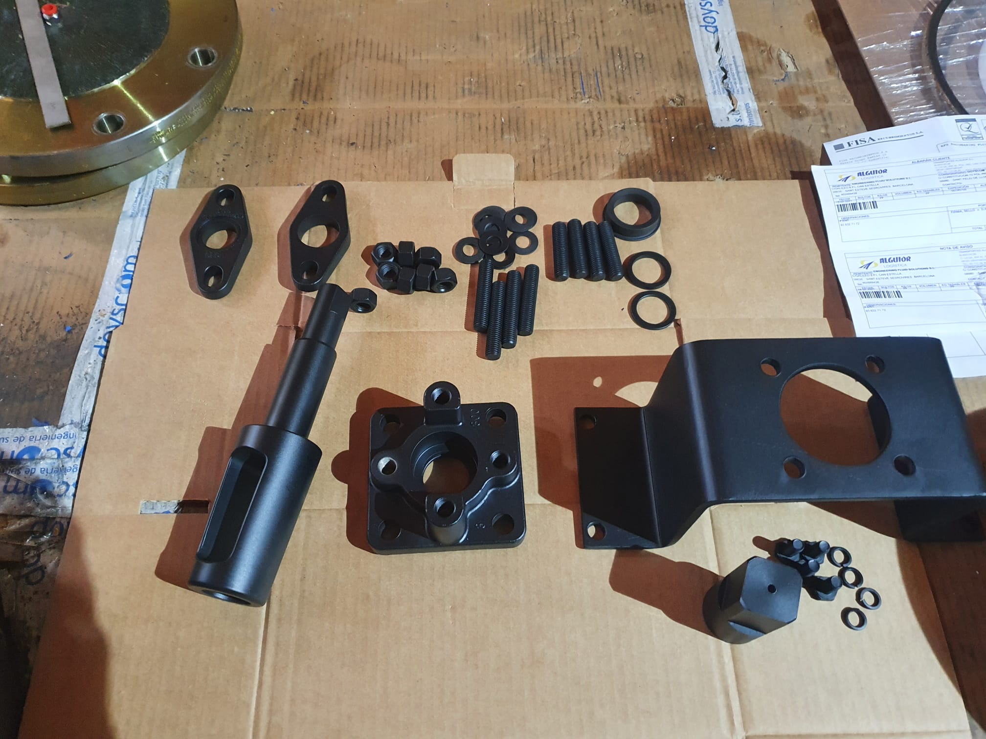 Plug valve stem, mounting bracket, fasteners and automation components prepared for assembly